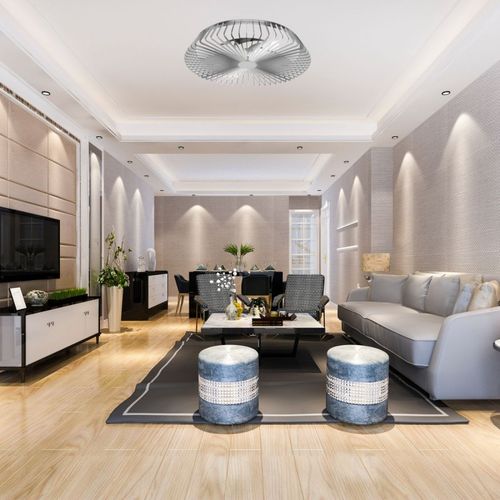 Salon moderne équipé d’un ventilateur sans pale au plafond, design aérodynamique et élégant au centre de la pièce.